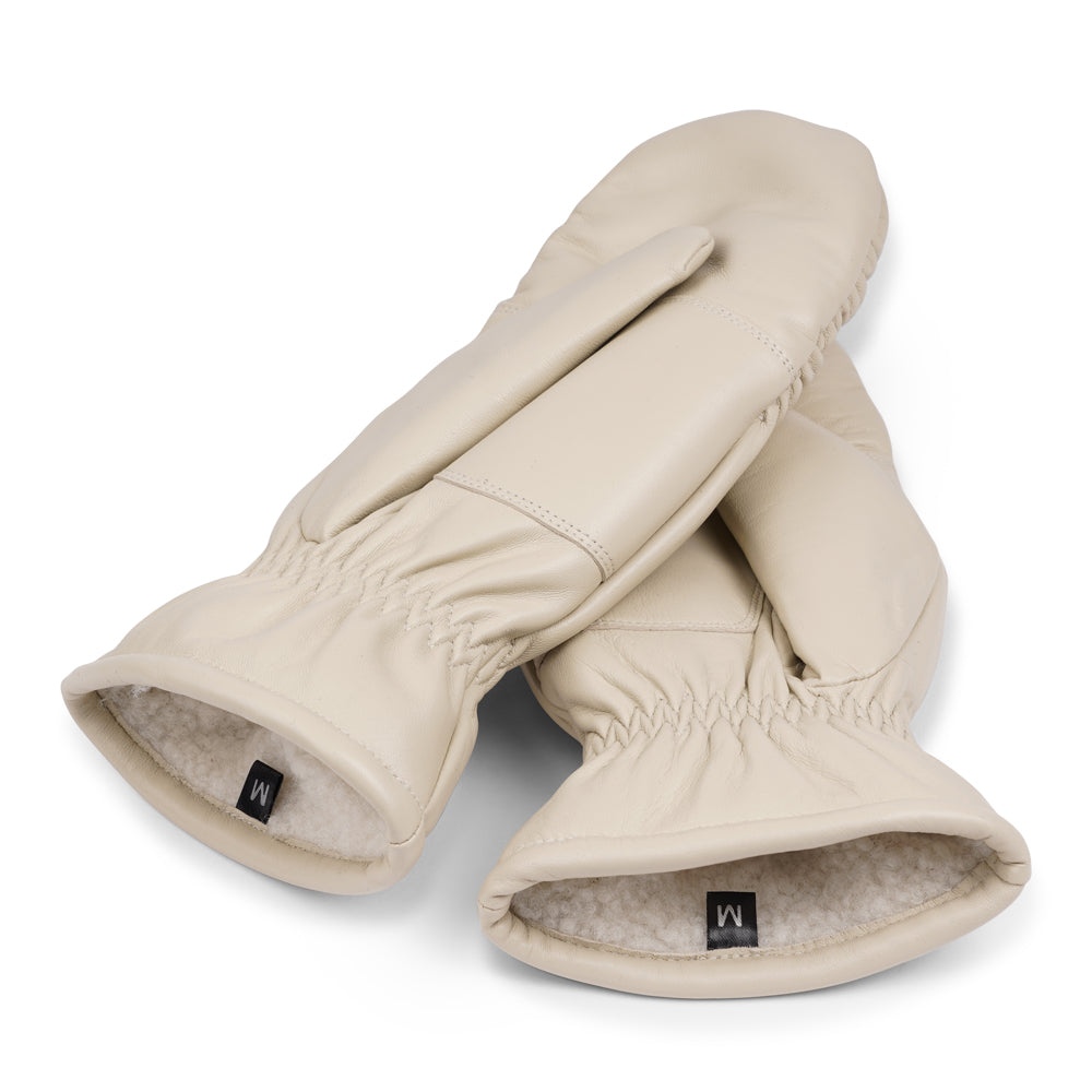 The Amalfi mittens are crafted from soft, premium leather and lined with cozy terry fleece for ultimate warmth and comfort. Designed for a sleek, timeless look, they feature an elastic wrist for a secure fit. Perfect for cold days, these luxurious mittens combine style and practicality with ease.