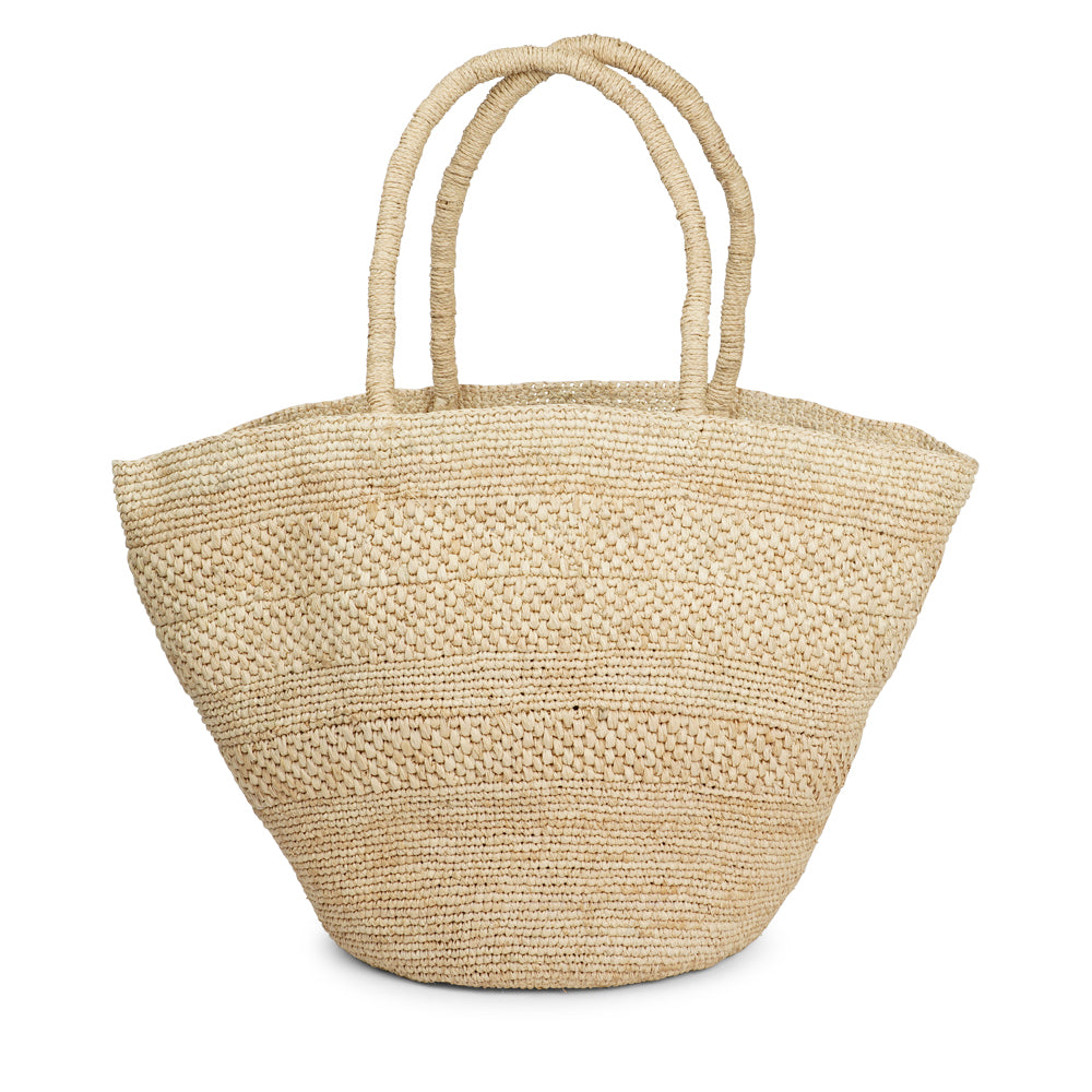 Anakao, the charming bag fashioned from luxurious raffia sourced from Madagascar.  Tailored for your everyday adventures, this tote boasts a spacious main compartment to accommodate all your necessities while you're on the move.  Raffia, derived from the resilient leaves of the palm tree, is celebrated for its versatility and eco-conscious qualities, making it a sought-after material in the realm of fashion accessories. Lovelies Studio