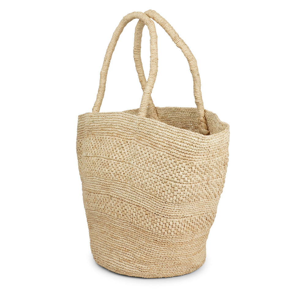 Anakao, the charming bag fashioned from luxurious raffia sourced from Madagascar.  Tailored for your everyday adventures, this tote boasts a spacious main compartment to accommodate all your necessities while you're on the move.  Raffia, derived from the resilient leaves of the palm tree, is celebrated for its versatility and eco-conscious qualities, making it a sought-after material in the realm of fashion accessories. Lovelies Studio