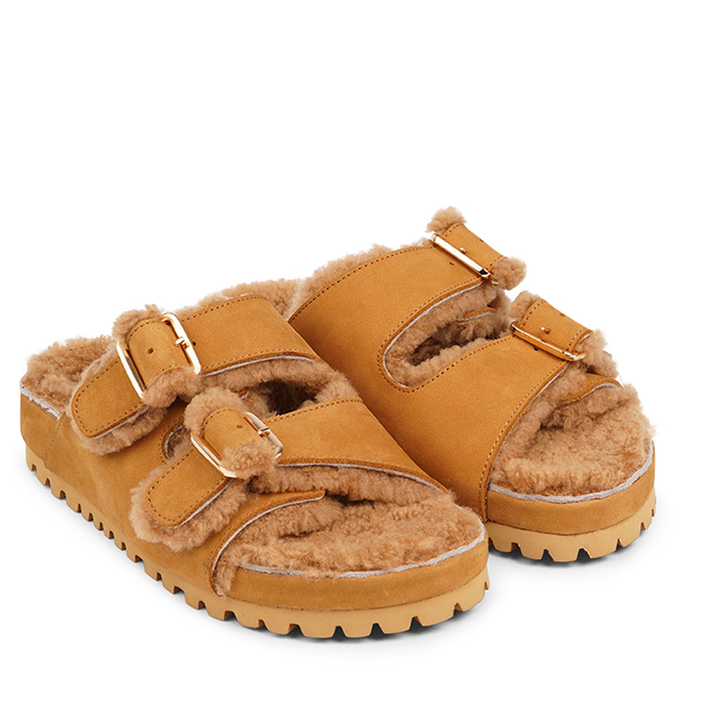 Adjustable nubuck sandals with shearling lining Lovelies shearling sandals will bring softness and warmth to your feet. They are perfect for early spring or autumn or even for a chilly summer night. The combination of soft shearling and the durable cork and rubber sole guarantees the utmost comfort to the wearer.