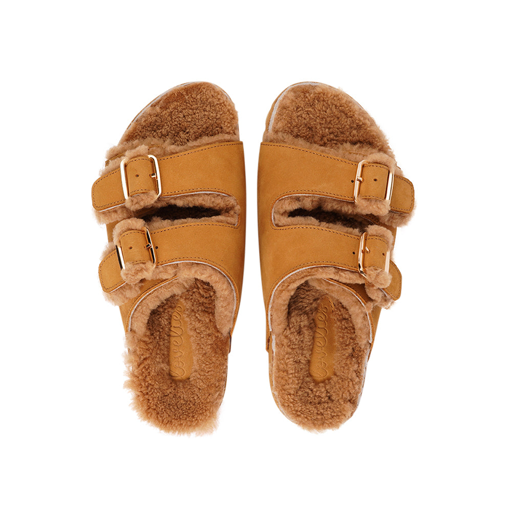 Adjustable nubuck sandals with shearling lining Lovelies shearling sandals will bring softness and warmth to your feet. They are perfect for early spring or autumn or even for a chilly summer night. The combination of soft shearling and the durable cork and rubber sole guarantees the utmost comfort to the wearer.