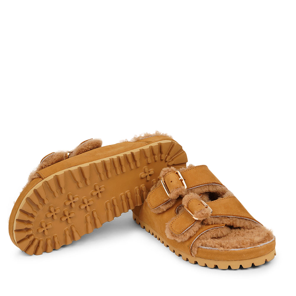 Adjustable nubuck sandals with shearling lining Lovelies shearling sandals will bring softness and warmth to your feet. They are perfect for early spring or autumn or even for a chilly summer night. The combination of soft shearling and the durable cork and rubber sole guarantees the utmost comfort to the wearer.