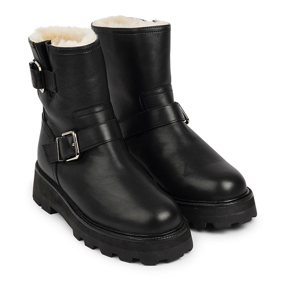 Lovelies Studio - Danish Design - Step into warmth and style this winter with our exquisite Dinara Winter Boot. Crafted to keep you snug and stylish through the coldest months.  The Dinara Winter Boot boasts a robust, thick rubber sole, providing superior traction and durability, so you can confidently navigate snowy streets and icy pathways. The upper is handcrafted in supple nappa leather.   Two adjustable buckles grace the boot's upper, allowing you to personalize the fit to your preference