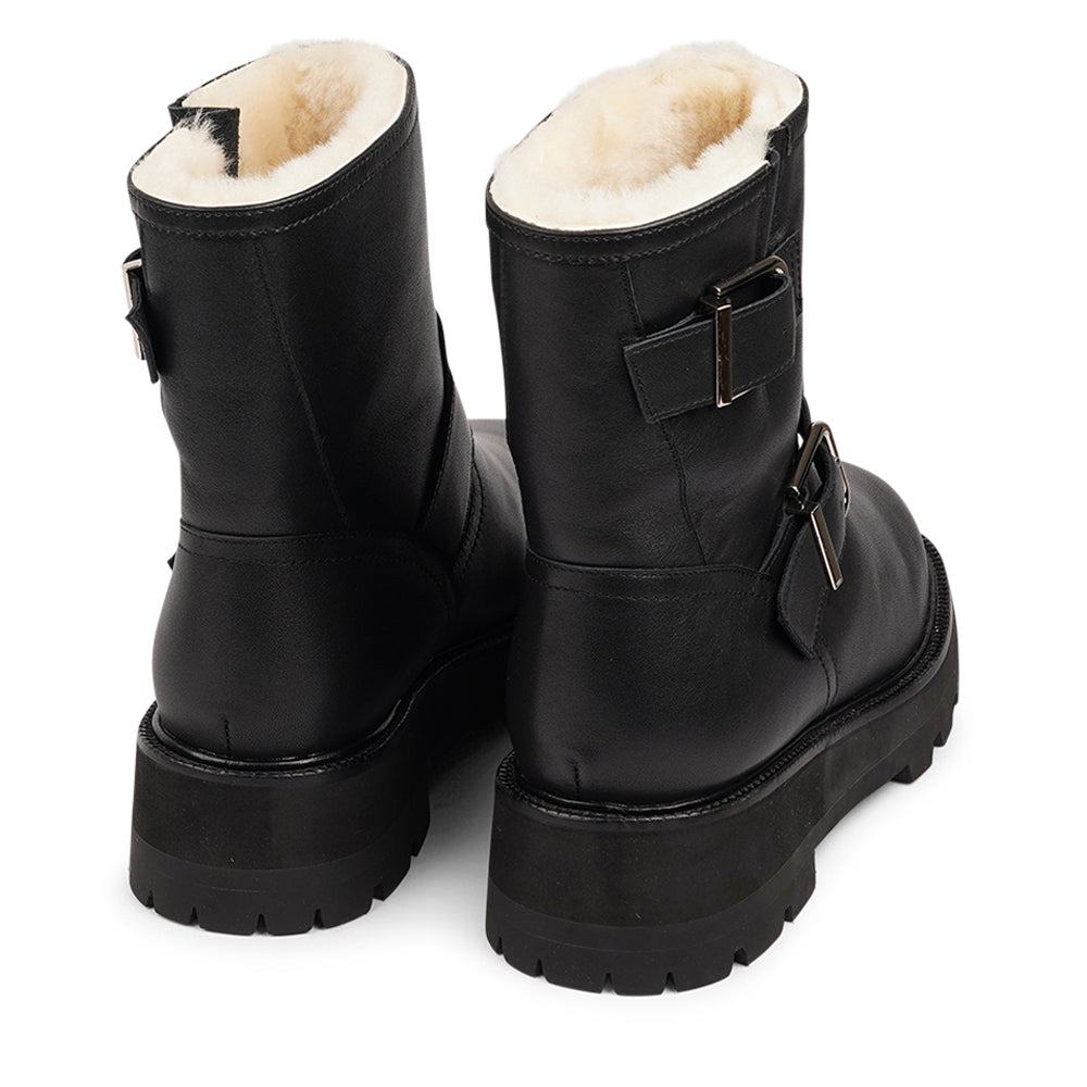 Lovelies Studio - Danish Design - Step into warmth and style this winter with our exquisite Dinara Winter Boot. Crafted to keep you snug and stylish through the coldest months. The Dinara Winter Boot boasts a robust, thick rubber sole, providing superior traction and durability, so you can confidently navigate snowy streets and icy pathways. The upper is handcrafted in supple nappa leather. Two adjustable buckles grace the boot's upper, allowing you to personalize the fit to your preference