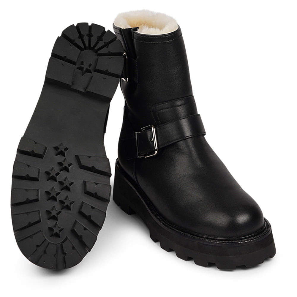 Lovelies Studio - Danish Design - Step into warmth and style this winter with our exquisite Dinara Winter Boot. Crafted to keep you snug and stylish through the coldest months. The Dinara Winter Boot boasts a robust, thick rubber sole, providing superior traction and durability, so you can confidently navigate snowy streets and icy pathways. The upper is handcrafted in supple nappa leather. Two adjustable buckles grace the boot's upper, allowing you to personalize the fit to your preference