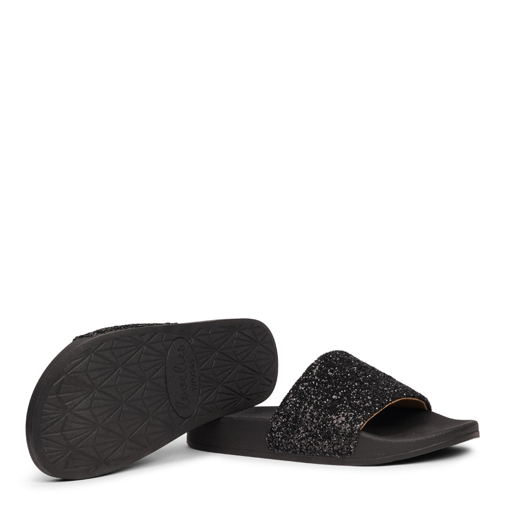 Shine all summer with Fontazzi Glitter Slides!
Perfect for any occasion, these slides feature a full glitter design that adds a touch of sparkle to your look. With a durable yet soft rubber sole, they offer all-day comfort whether you're partying or lounging by the beach.
Step into the spotlight with Fontazzi – the ultimate combination of fun, comfort, and shine!