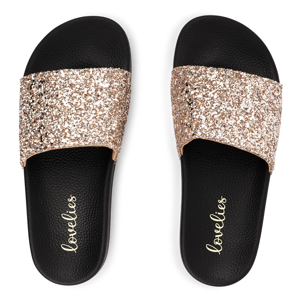 Shine all summer with Fontazzi Glitter Slides!
Perfect for any occasion, these slides feature a full glitter design that adds a touch of sparkle to your look. With a durable yet soft rubber sole, they offer all-day comfort whether you're partying or lounging by the beach.
Step into the spotlight with Fontazzi – the ultimate combination of fun, comfort, and shine!