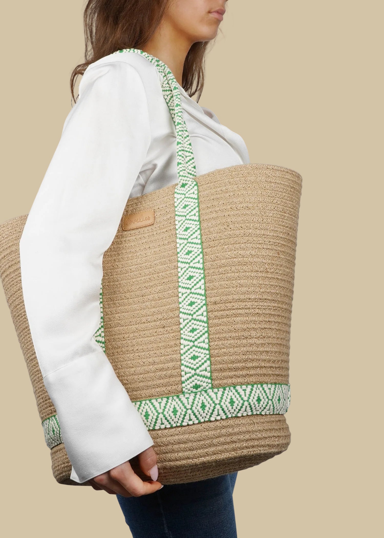 This chic and practical carryall blends natural materials with a vibrant touch of pattern. Crafted from sturdy rope in a warm neutral shade, it showcases eye-catching, colorful woven webbing straps that enhance both its style and structure. Lightweight and roomy, it's ideal for beach days, market visits, or carrying everyday essentials.