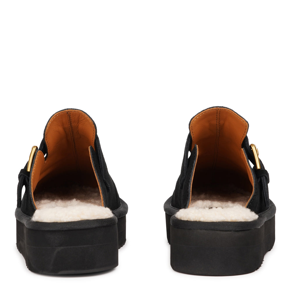 Lovelies Studio - Kokubo – Suede Mules with Adjustable Buckle
Meet Kokubo — a pair of mules that redefine everyday comfort with understated elegance. What makes them special is the plush shearling insole that gently cushions your feet, offering natural warmth and luxurious softness, even on a cold days.
Crafted from premium suede and finished with a durable rubber sole, the Kokubo mules combine style, comfort, and longevity in one effortless design.