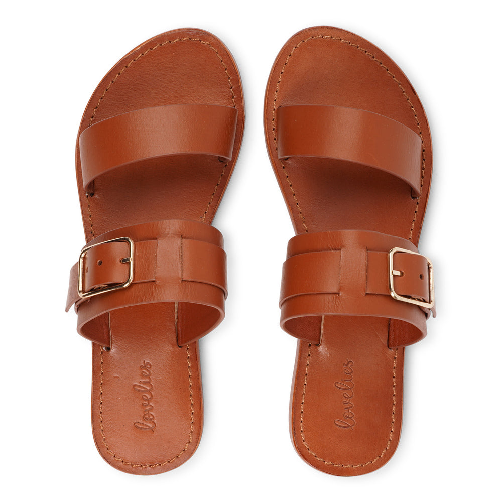 Lacco is our beautifully handcrafted leather sandal, designed to bring feminine elegance and all-day ease to your wardrobe. Featuring a single adjustable buckle for a secure, personalized fit, Lacco strikes the perfect balance between style and functionality.
Made from vegetable-tanned buffalo leather, the soft yet sturdy straps offer lasting comfort. The leather sole with a rubber grip provides reliable traction, whether you're dressing up or keeping it casual.