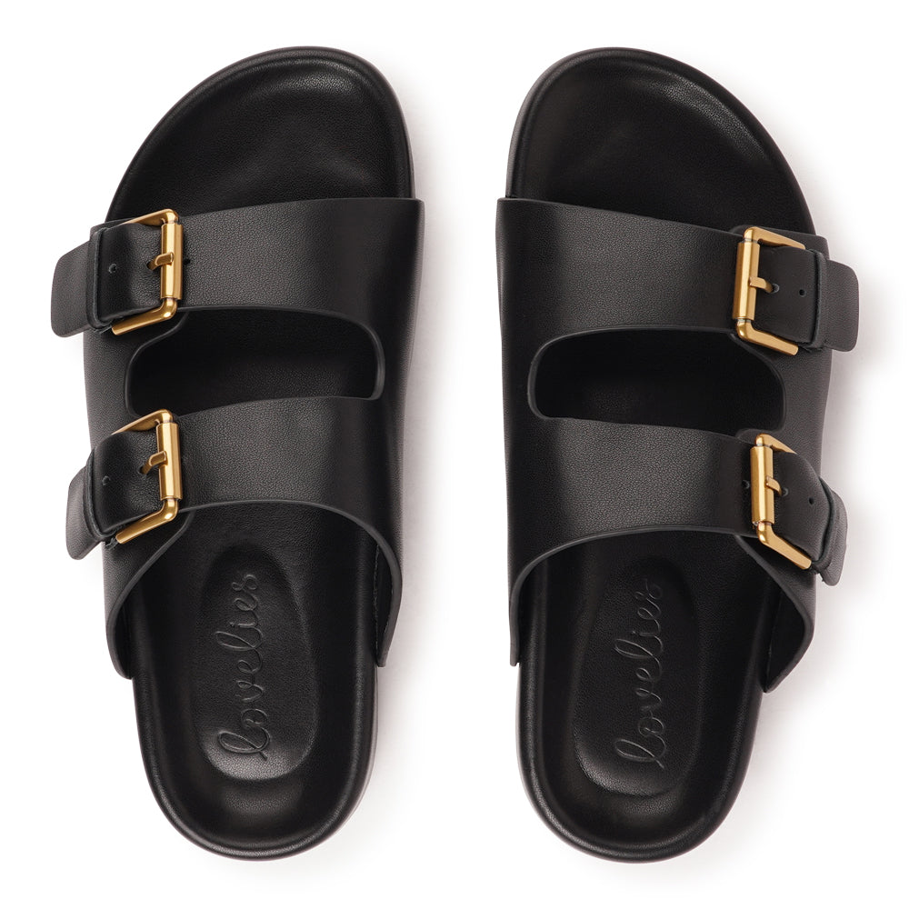 Effortlessly laid-back with a touch of understated luxury, these suede sandals are designed for all-day comfort and timeless appeal. Crafted from rich, soft leather, they feature two wide straps with adjustable silver-tone buckles for a customizable fit. The contoured footbed offers light support, while the flexible sole ensures ease of movement from indoors to out.