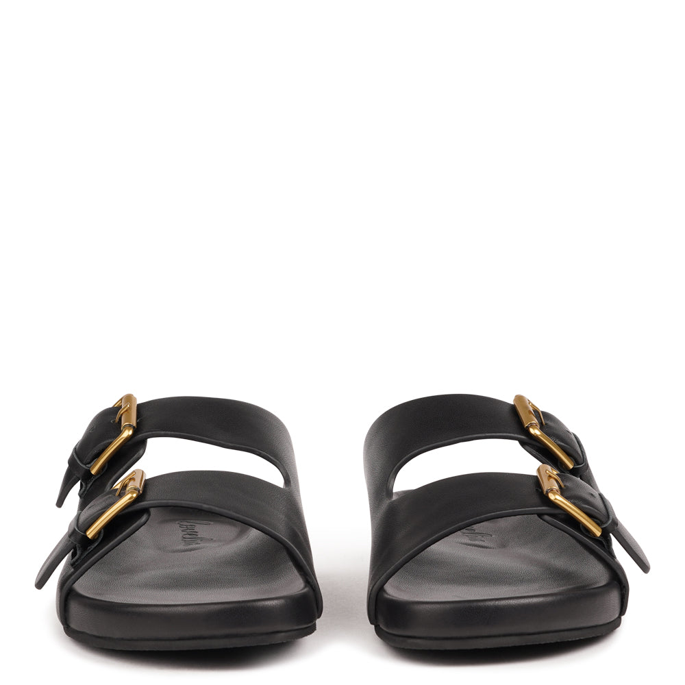 Effortlessly laid-back with a touch of understated luxury, these suede sandals are designed for all-day comfort and timeless appeal. Crafted from rich, soft leather, they feature two wide straps with adjustable silver-tone buckles for a customizable fit. The contoured footbed offers light support, while the flexible sole ensures ease of movement from indoors to out.