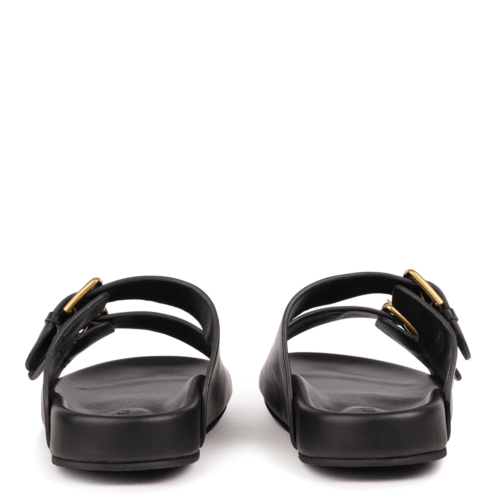 Effortlessly laid-back with a touch of understated luxury, these suede sandals are designed for all-day comfort and timeless appeal. Crafted from rich, soft leather, they feature two wide straps with adjustable silver-tone buckles for a customizable fit. The contoured footbed offers light support, while the flexible sole ensures ease of movement from indoors to out.