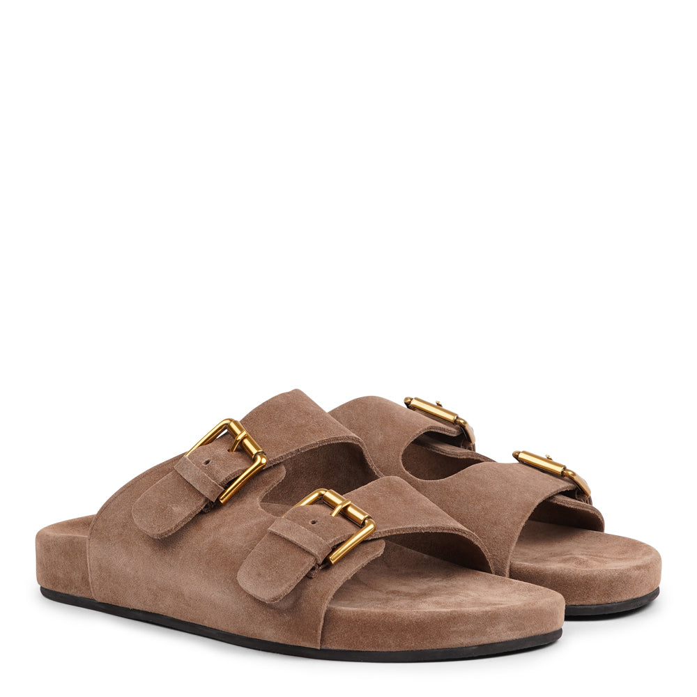 Lovelies Studio - Effortlessly laid-back with a touch of understated luxury, these suede sandals are designed for all-day comfort and timeless appeal. Crafted from rich, soft suede, they feature two wide straps with adjustable gold-tone buckles for a customizable fit. The contoured footbed offers light support, while the flexible sole ensures ease of movement from indoors to out.
Perfect for casual days, warm getaways, or everyday lounging in style.
Adjustable straps with metal buckles
Soft, cushioned foot