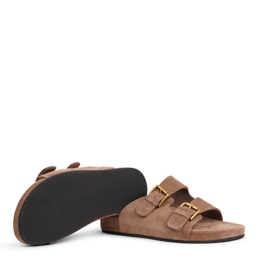 Lovelies Studio - Effortlessly laid-back with a touch of understated luxury, these suede sandals are designed for all-day comfort and timeless appeal. Crafted from rich, soft suede, they feature two wide straps with adjustable gold-tone buckles for a customizable fit. The contoured footbed offers light support, while the flexible sole ensures ease of movement from indoors to out.
Perfect for casual days, warm getaways, or everyday lounging in style.
Adjustable straps with metal buckles
Soft, cushioned foot