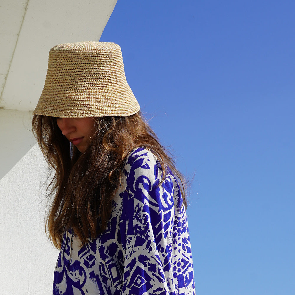 Lovelies Studio - Made from raffia, a natural fiber renowned for its durability and flexibility, the Marconi bucket hat is not only stylish but also eco-friendly. The raffia is carefully colored by hand using traditional methods and left to dry naturally in the warm sun, ensuring minimal environmental impact.