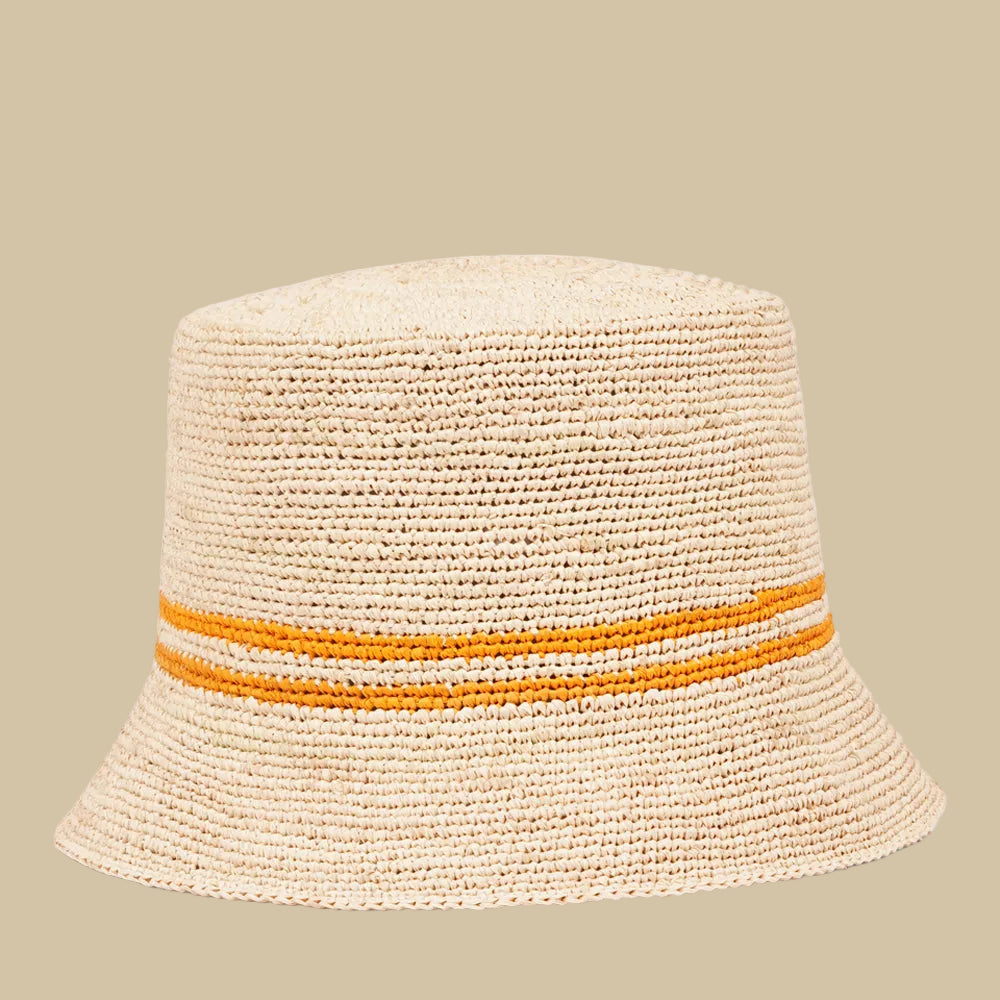 Lovelies Studio - The Marconi bucket hat, a stunning creation meticulously crafted by local artisans in Madagascar exclusively for Lovelies Studio. Made from raffia, a natural fiber renowned for its durability and flexibility, the Marconi bucket hat is not only stylish but also eco-friendly. The raffia is carefully colored by hand using traditional methods and left to dry naturally in the warm sun, ensuring minimal environmental impact.