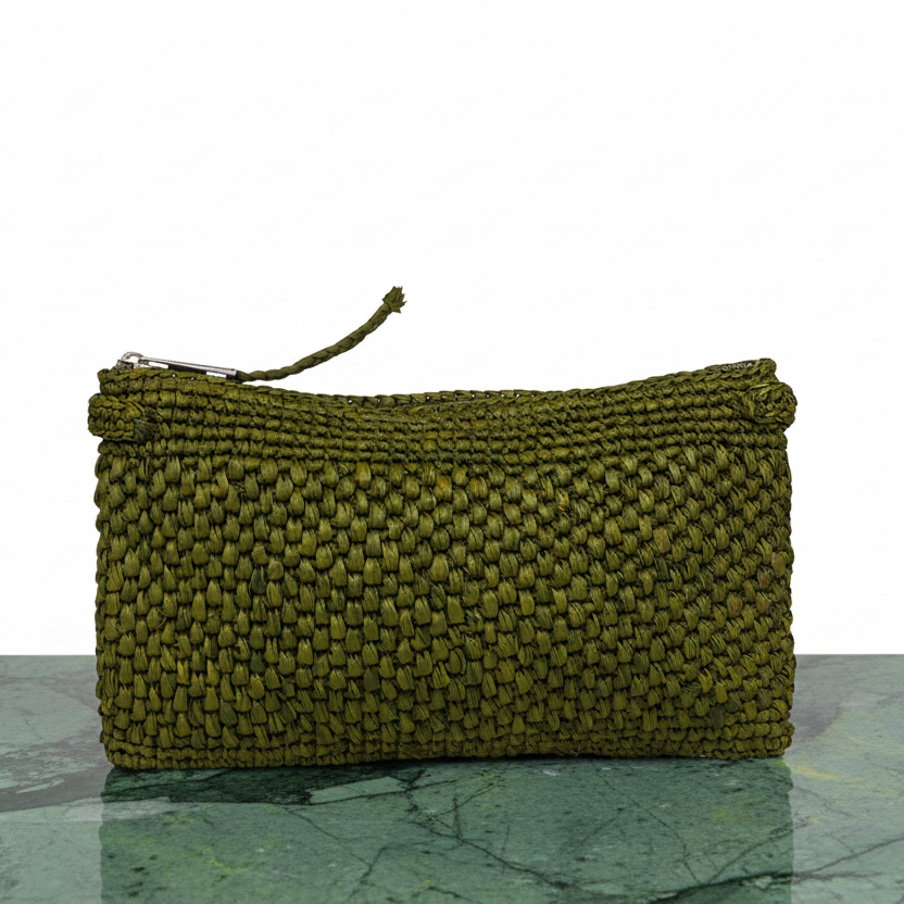 Meliso, the little charming clutch fashioned from luxurious raffia sourced from Madagascar.
Raffia, derived from the resilient leaves of the palm tree, is celebrated for its versatility and eco-conscious qualities, making it a sought-after material in the realm of fashion accessories.