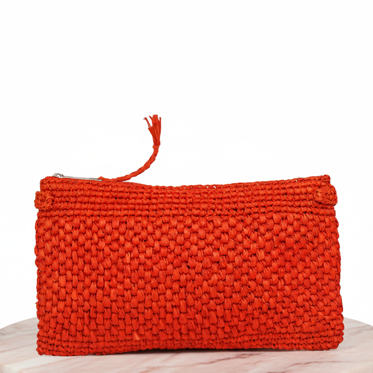 Meliso, the little charming clutch fashioned from luxurious raffia sourced from Madagascar.
Raffia, derived from the resilient leaves of the palm tree, is celebrated for its versatility and eco-conscious qualities, making it a sought-after material in the realm of fashion accessories.
Handcrafted with precision, raffia handbags epitomize a blend of casual sophistication, suitable for a myriad of occasions, be it a leisurely outing or a formal affair. The subtle texture and natural hues of raffia lend an u