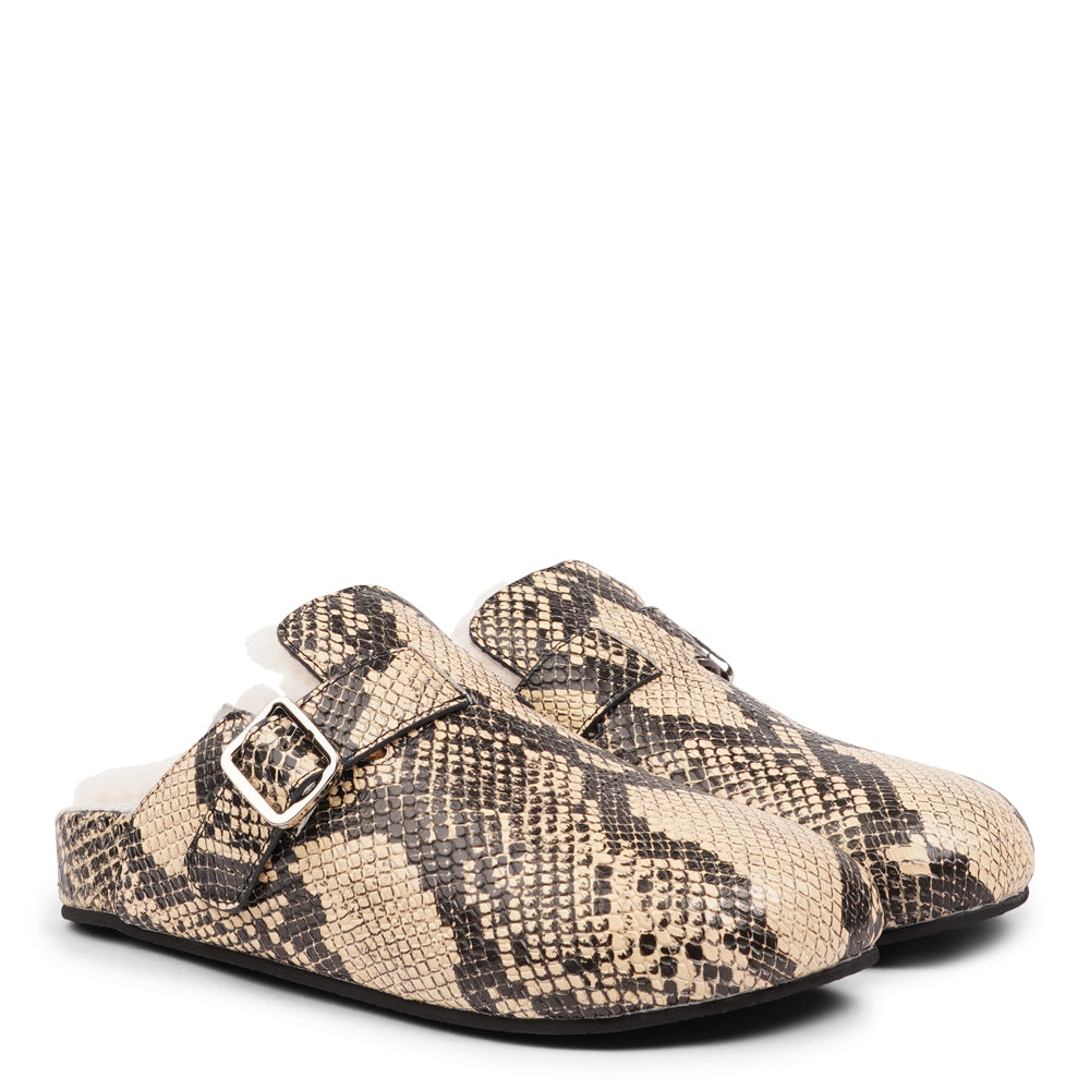 Lovelies Studio - The Nesso Snake Mules are the epitome of luxurious comfort and style. Crafted with a premium leather upper, these exclusive mules feature an adjustable buckle for a customized fit. Lined with soft curly shearling, they provide warmth and a cozy feel, perfect for cooler days.