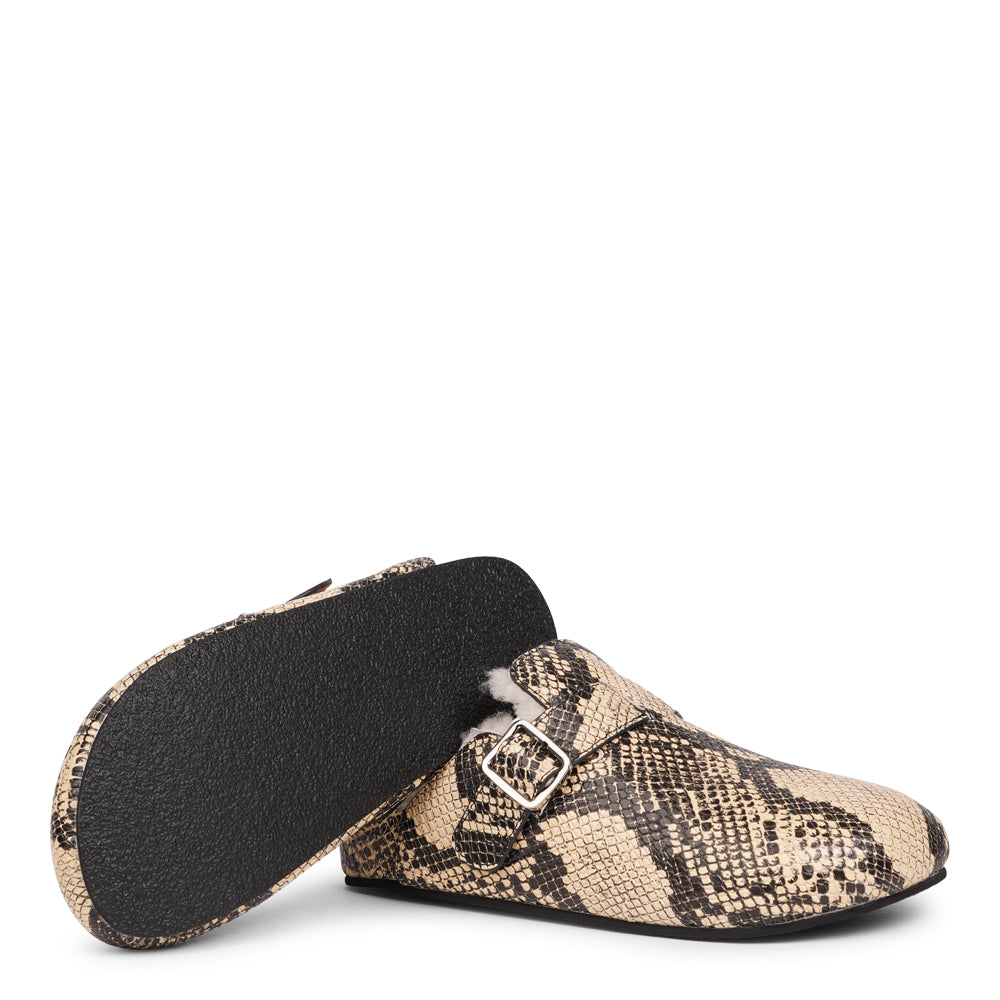 Lovelies Studio - The Nesso Snake Mules are the epitome of luxurious comfort and style. Crafted with a premium leather upper, these exclusive mules feature an adjustable buckle for a customized fit. Lined with soft curly shearling, they provide warmth and a cozy feel, perfect for cooler days.