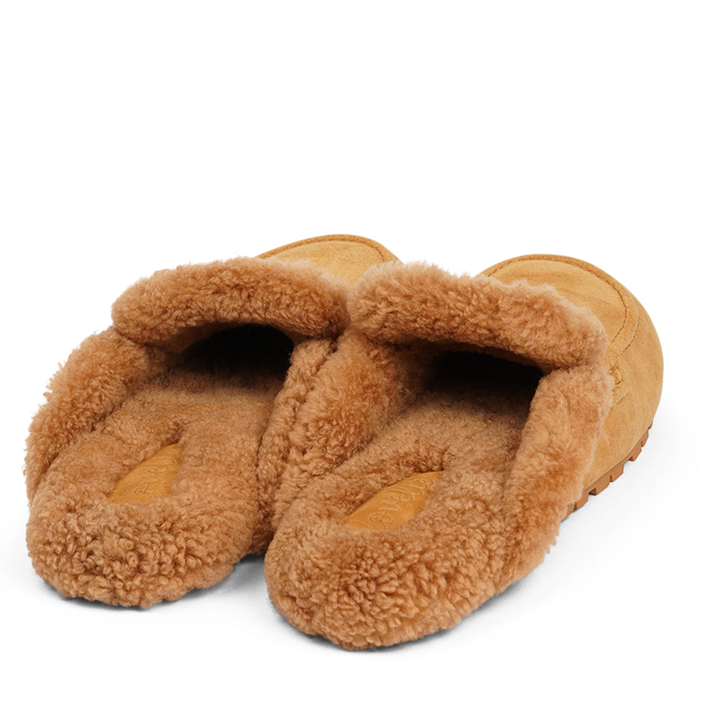 Rees - Lovelies Studio. Suede Mules with curly shearling lining Lovelies shearling mules will bring softness and warmth to your feet this autumn. The combination of soft curly shearling and the durable cork and rubber sole and guarantees the utmost comfort to the wearer.
