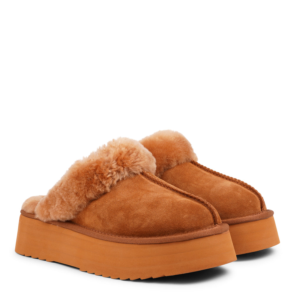 Lovelies - What sets the Robson mules apart is their plush shearling lining, which envelops your feet in a cloud-like cocoon of comfort. The shearling not only adds a touch of opulence but also provides natural insulation, keeping your feet toasty even on the chilliest of days.  But comfort isn't just skin-deep with the Robson mules. The combination of premium suede and the resilient rubber sole ensures durability and longevity, making these mules a dependable choice for daily wear.