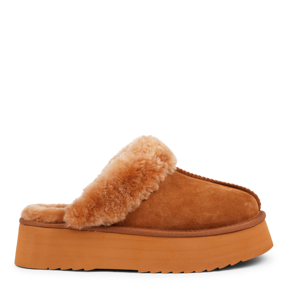 Lovelies - What sets the Robson mules apart is their plush shearling lining, which envelops your feet in a cloud-like cocoon of comfort. The shearling not only adds a touch of opulence but also provides natural insulation, keeping your feet toasty even on the chilliest of days.  But comfort isn't just skin-deep with the Robson mules. The combination of premium suede and the resilient rubber sole ensures durability and longevity, making these mules a dependable choice for daily wear.