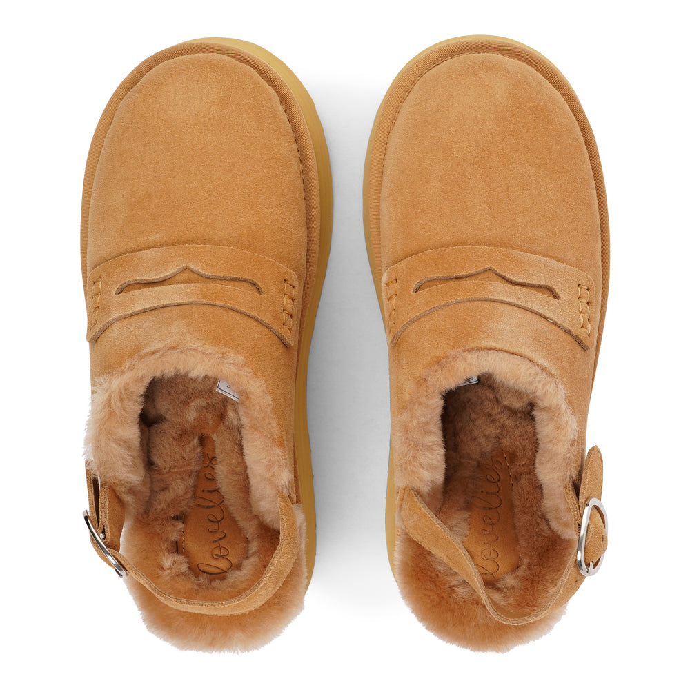 Step into a world of luxury and coziness with our Siple suede mules. Crafted with the finest suede, these mules are designed to provide not only elegance but also ultimate comfort for your feet. The sumptuous shearling lining ensures your feet stay warm and snug, making them the perfect choice for colder days.  The standout feature of the Siple mules is the adjustable heel strap, allowing you to customize the fit to your liking.