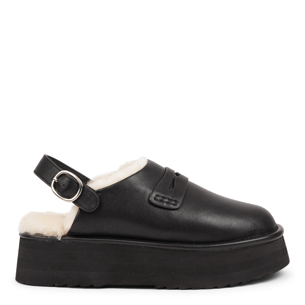 Step into a world of luxury and coziness with our Siple suede mules. Crafted with the finest suede, these mules are designed to provide not only elegance but also ultimate comfort for your feet. The sumptuous shearling lining ensures your feet stay warm and snug, making them the perfect choice for colder days.  The standout feature of the Siple mules is the adjustable heel strap, allowing you to customize the fit to your liking.