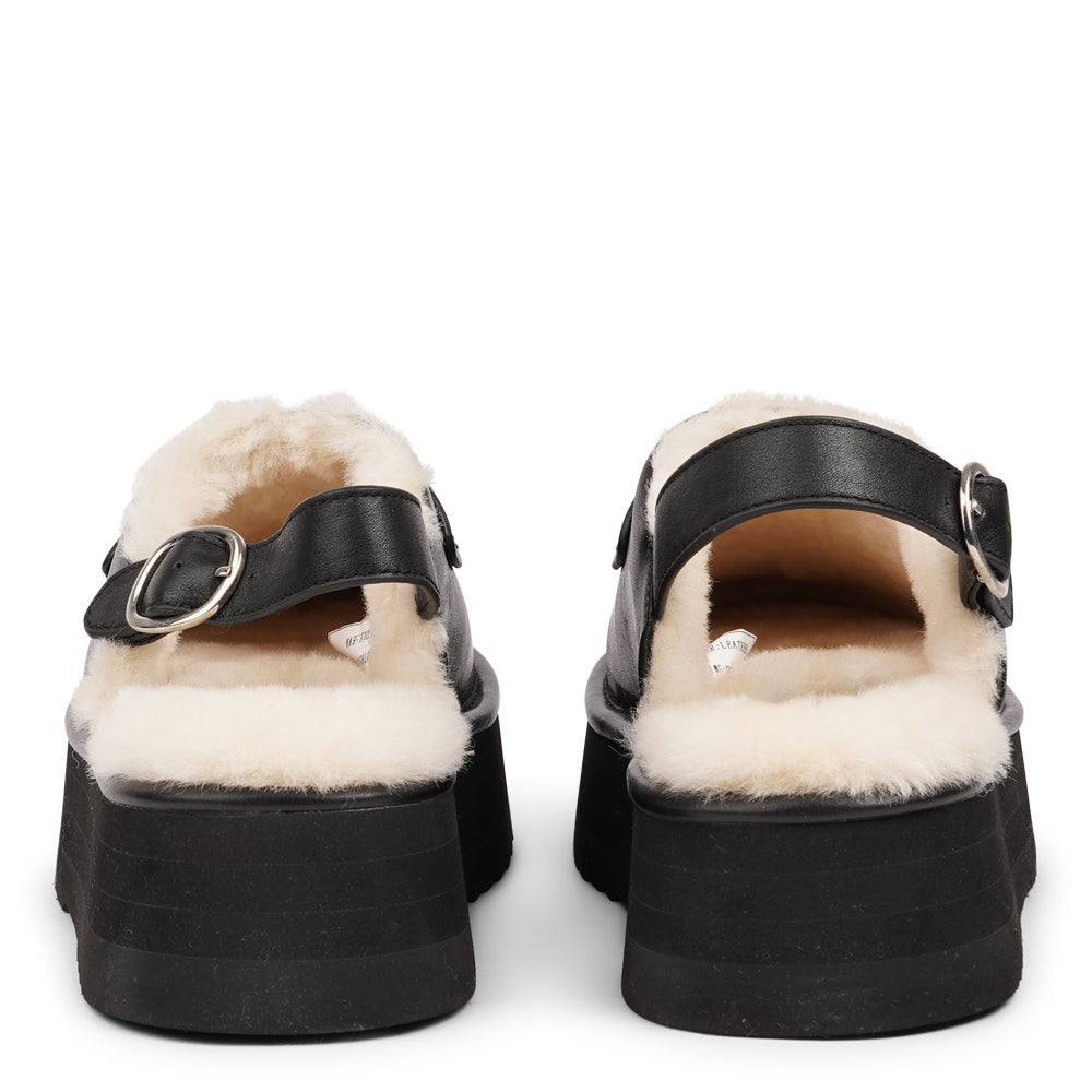 Step into a world of luxury and coziness with our Siple suede mules. Crafted with the finest suede, these mules are designed to provide not only elegance but also ultimate comfort for your feet. The sumptuous shearling lining ensures your feet stay warm and snug, making them the perfect choice for colder days.  The standout feature of the Siple mules is the adjustable heel strap, allowing you to customize the fit to your liking.