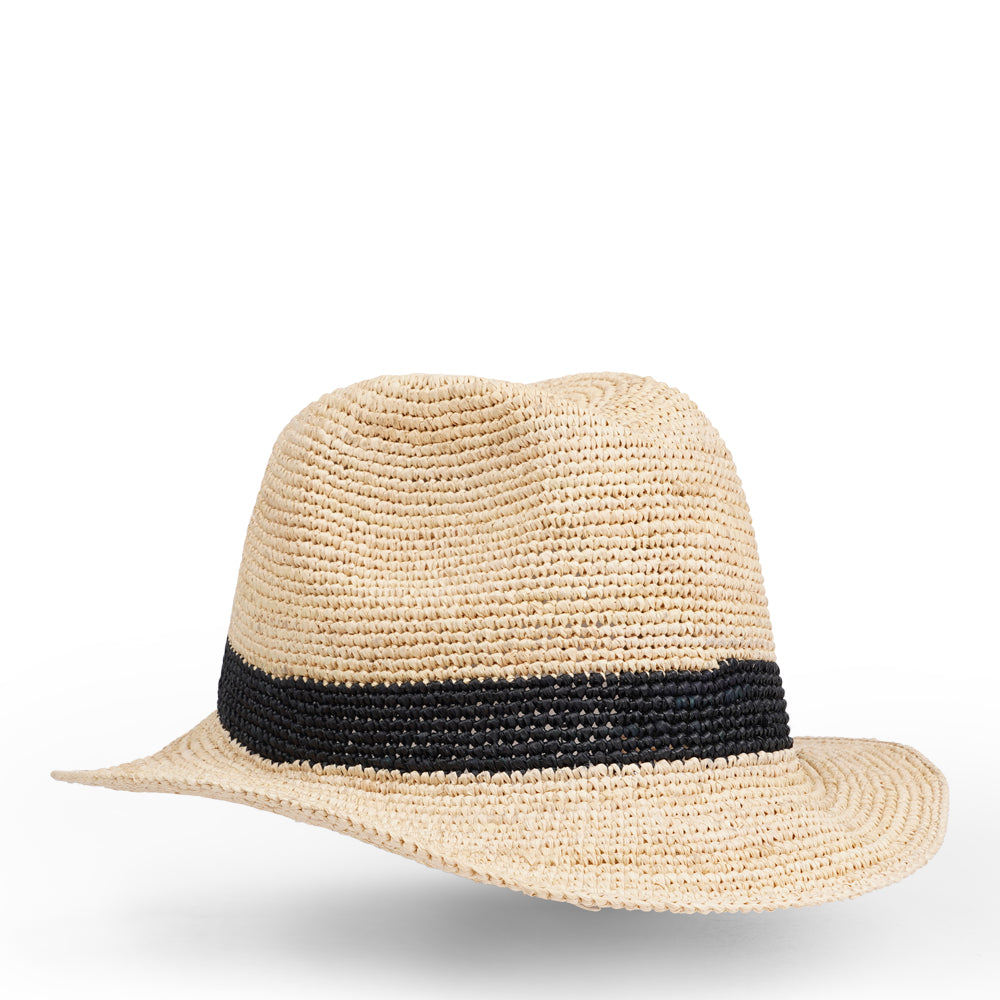 The Summery Viviani hat, a stunning creation meticulously crafted by local artisans in Madagascar exclusively for Lovelies Studio. Each piece is a testament to the skill and dedication of these artisans, who handcraft every detail with precision and care.  Made from raffia, a natural fiber renowned for its durability and flexibility, the Viviani hat is not only stylish but also eco-friendly. The raffia is carefully colored by hand using traditional methods