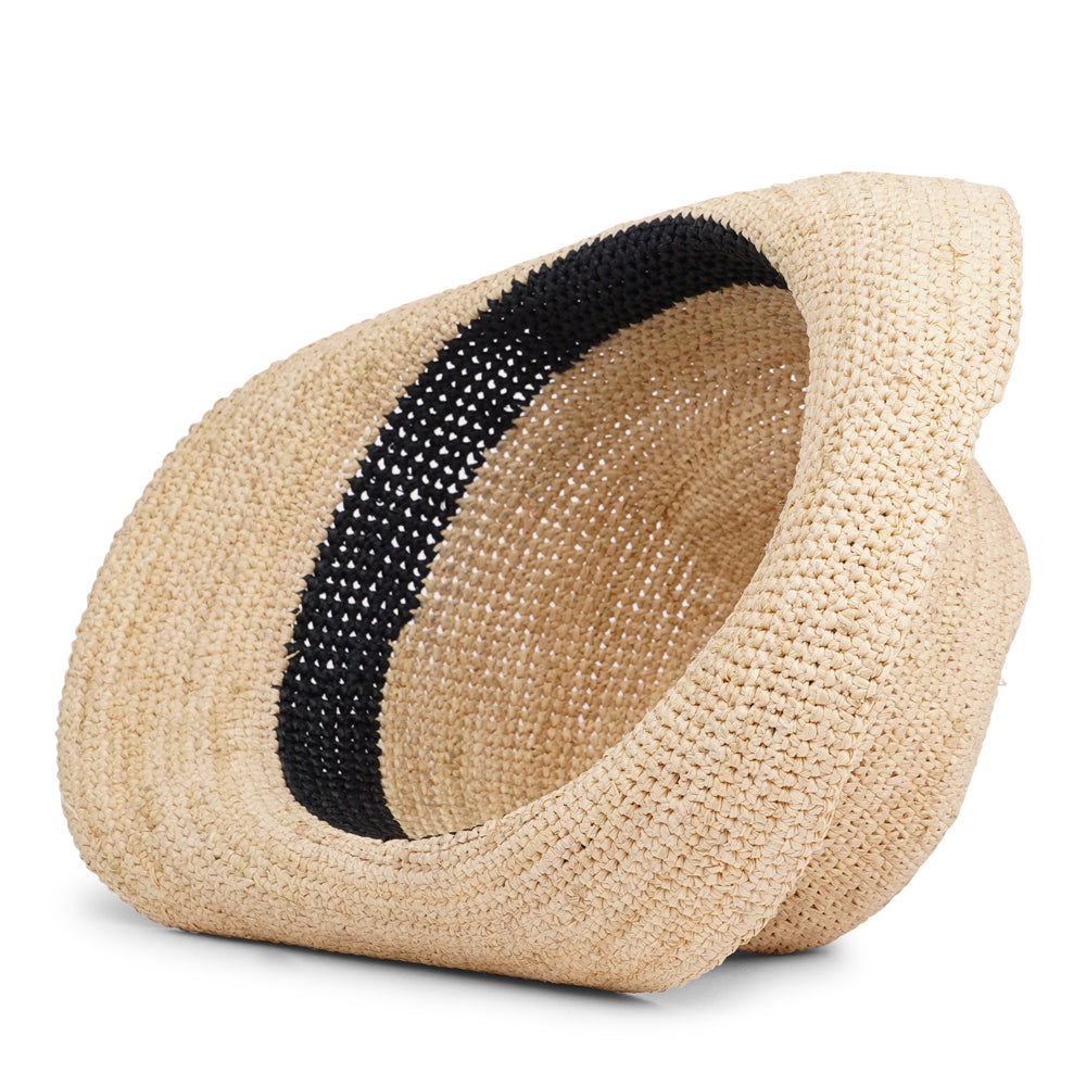 The Summery Viviani hat, a stunning creation meticulously crafted by local artisans in Madagascar exclusively for Lovelies Studio. Each piece is a testament to the skill and dedication of these artisans, who handcraft every detail with precision and care. Made from raffia, a natural fiber renowned for its durability and flexibility, the Viviani hat is not only stylish but also eco-friendly. The raffia is carefully colored by hand using traditional methods
