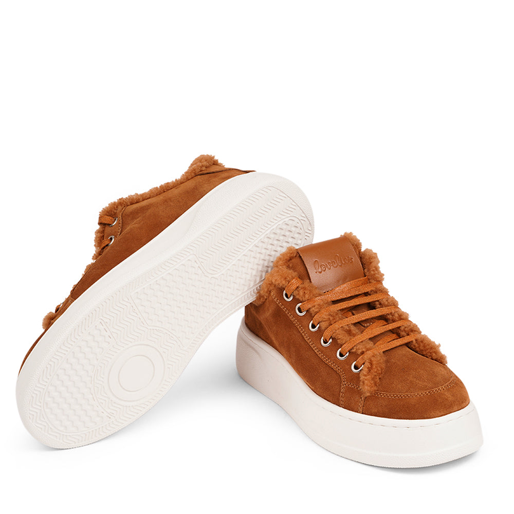 At the foundation of the Zanja low sneaker lies a soft yet durable rubber sole, ensuring long-lasting wear and exceptional grip. The upper is adorned with suede and features charming shearling details, adding a touch of luxury to your every step. Whether you're dressing up for a night out or aiming for a more casual look, these sneakers effortlessly elevate your style.