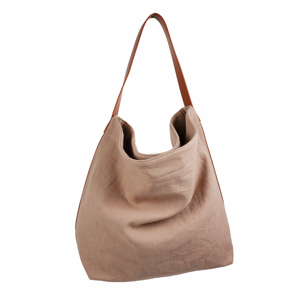 Our Lovelies casual shoulder shopper bag is made of high quality linen and a soft 100% leather handle. The bag has a large primary compartment in which you can fit in all of your stuff when you're on the go.    Inside the shopper bag there's a magnetic button closure at the top as well as a  phone pocket.  60% Linen & 40% Cotton   Double Lining   100% Leather handle  Inside phone pocket  Size H41 x W52 x D20 cm