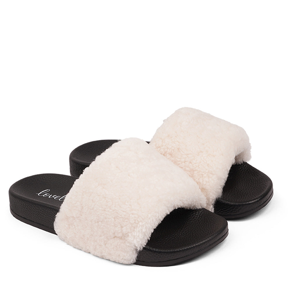 Slides with Australian Shearling upper.  This wonderful slide has a soft and light rubber sole which makes it very comfortable and an all time favorite sandal. The 100% shearling wool will keep you warm or cool you down on hot summer days.