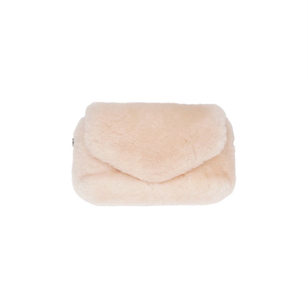 Lovelies Studio Understated and elegant, the little sister Corso shearling clutch with detachable crossbody strap comes in both black and cream. Corso is perfect for carrying your essentials with you for party or everyday use. Front flap with hidden magnetic fastening.   Adjustable and detachable wrist strap. Adjustable and detachable shoulder strap in leather. Shoulder strap 105 cm and 15 mm wide. Lining of suede and soft skin.  Flat zipped inner pocket.  Embossed Lovelies logo inside the bag