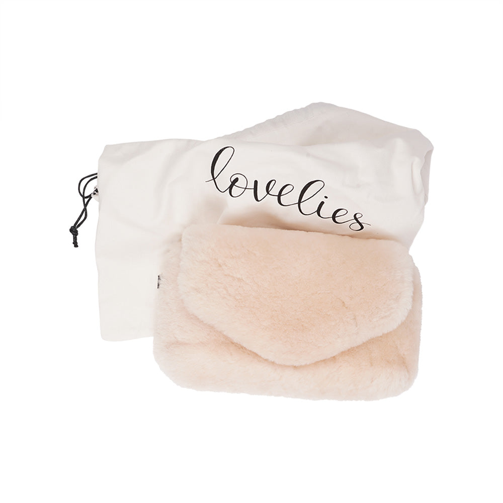 Lovelies Studio Understated and elegant, the little sister Corso shearling clutch with detachable crossbody strap comes in both black and cream. Corso is perfect for carrying your essentials with you for party or everyday use. Front flap with hidden magnetic fastening.   Adjustable and detachable wrist strap. Adjustable and detachable shoulder strap in leather. Shoulder strap 105 cm and 15 mm wide. Lining of suede and soft skin.  Flat zipped inner pocket.  Embossed Lovelies logo inside the bag