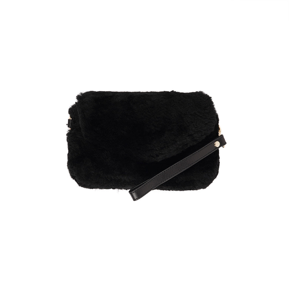 Lovelies Studio Understated and elegant, the little sister Corso shearling clutch with detachable crossbody strap comes in both black and cream. Corso is perfect for carrying your essentials with you for party or everyday use. Front flap with hidden magnetic fastening.   Adjustable and detachable wrist strap. Adjustable and detachable shoulder strap in leather. Shoulder strap 105 cm and 15 mm wide. Lining of suede and soft skin.  Flat zipped inner pocket.  Embossed Lovelies logo inside the bag 