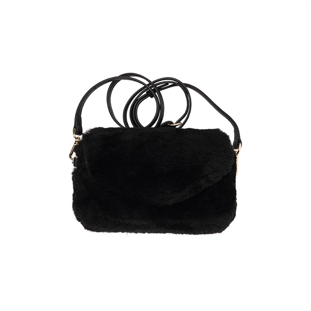 Lovelies Studio Understated and elegant, the little sister Corso shearling clutch with detachable crossbody strap comes in both black and cream. Corso is perfect for carrying your essentials with you for party or everyday use. Front flap with hidden magnetic fastening. Adjustable and detachable wrist strap. Adjustable and detachable shoulder strap in leather. Shoulder strap 105 cm and 15 mm wide. Lining of suede and soft skin. Flat zipped inner pocket. Embossed Lovelies logo inside the bag