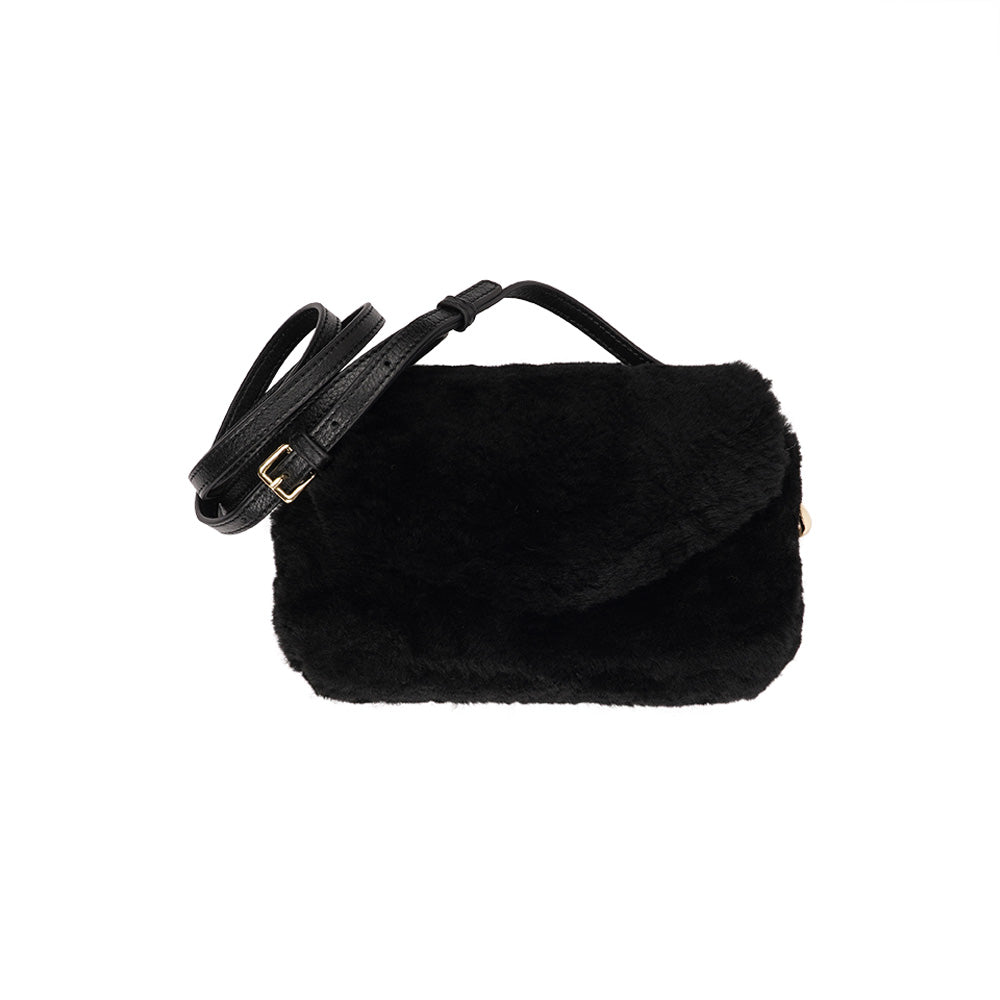 Lovelies Studio Understated and elegant, the little sister Corso shearling clutch with detachable crossbody strap comes in both black and cream. Corso is perfect for carrying your essentials with you for party or everyday use. Front flap with hidden magnetic fastening. Adjustable and detachable wrist strap. Adjustable and detachable shoulder strap in leather. Shoulder strap 105 cm and 15 mm wide. Lining of suede and soft skin. Flat zipped inner pocket. Embossed Lovelies logo inside the bag