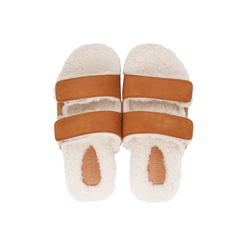 Lovelies Studio - Adjustable Nubuck sandals with shearling lining Lovelies shearling sandals will bring softness and warmth to your feet this autumn. The combination of soft shearling and rubber sole guarantees the utmost comfort to the wearer. Lovelies Studio is a Danish brand.