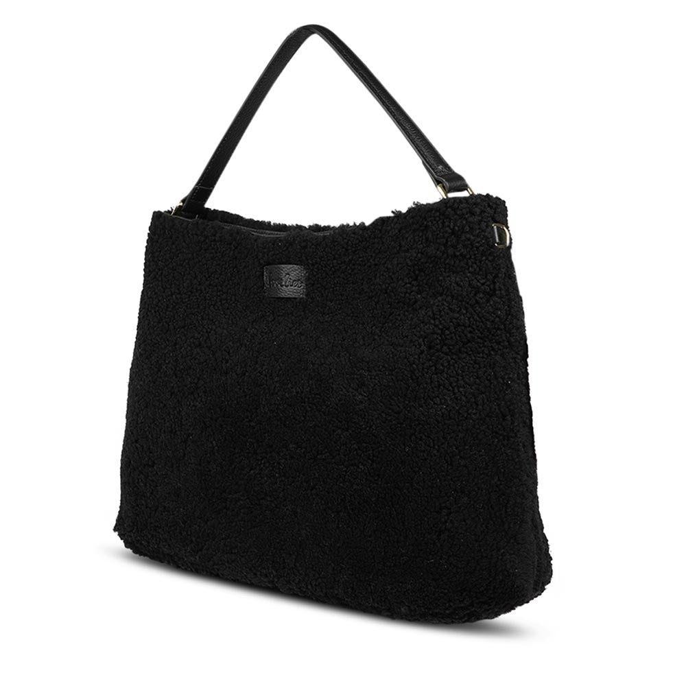 Mainling is a tribute to craftsmanship and the handmade, this large and very soft bag comes in curly shearling and with beautiful leather details. * Top double zipped closure. * Top handle in soft skin with hardware in gold. * Adjustable and detachable shoulder strap in leather, 15 mm wide. * Satin lining and flat zipped inner pocket * Item comes with a branded dust bag. * Embossed Lovelies logo on the front. * Gold-toned hardware * Messurements W40 X D10 X H30 cm * 100 % Australian shearling