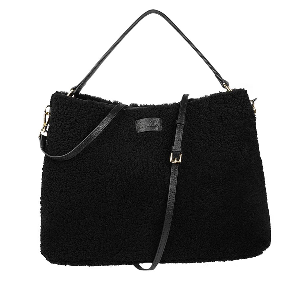 Mainling is a tribute to craftsmanship and the handmade, this large and very soft bag comes in curly shearling and with beautiful leather details. * Top double zipped closure. * Top handle in soft skin with hardware in gold. * Adjustable and detachable shoulder strap in leather, 15 mm wide. * Satin lining and flat zipped inner pocket * Item comes with a branded dust bag. * Embossed Lovelies logo on the front. * Gold-toned hardware * Messurements W40 X D10 X H30 cm * 100 % Australian shearling