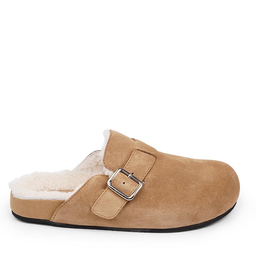 Suede Mules with adjustable buckle and curly shearling lining  Lovelies shearling mules will bring softness and warmth to your feet this summer. The combination of soft curly shearling and the durable rubber sole guarantees the utmost comfort to the wearer. Nesso Mules in Sand from Danish Lovelies Studio.