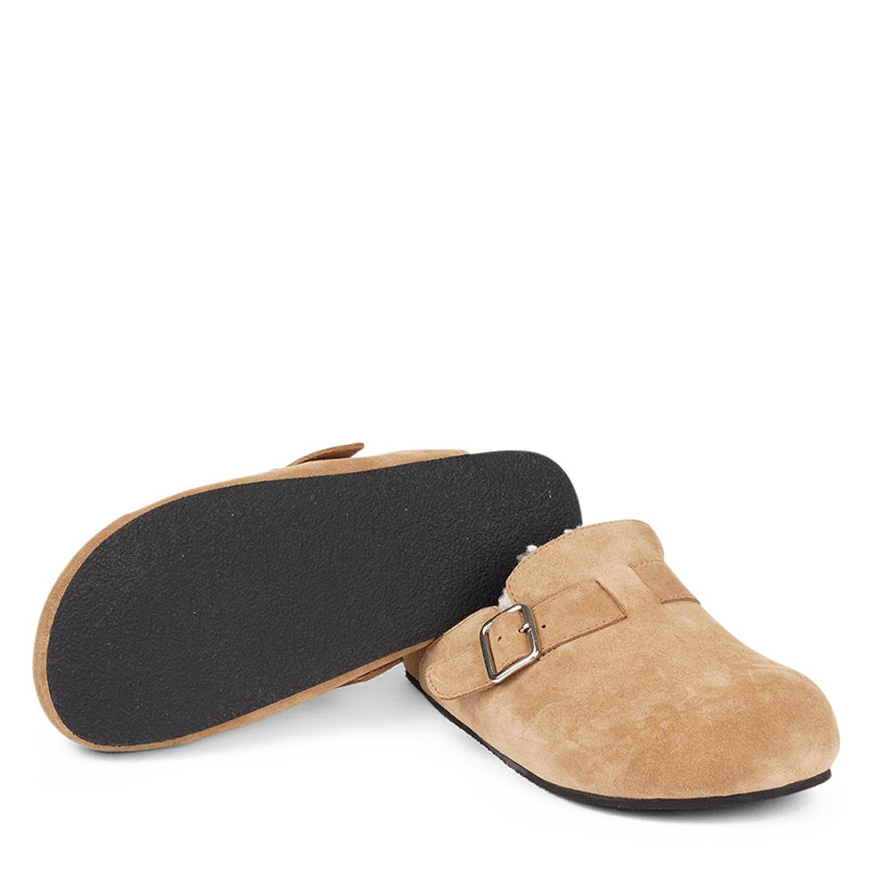 Suede Mules with adjustable buckle and curly shearling lining  Lovelies shearling mules will bring softness and warmth to your feet this summer. The combination of soft curly shearling and the durable rubber sole guarantees the utmost comfort to the wearer. Nesso Mules in Sand from Danish Lovelies Studio.