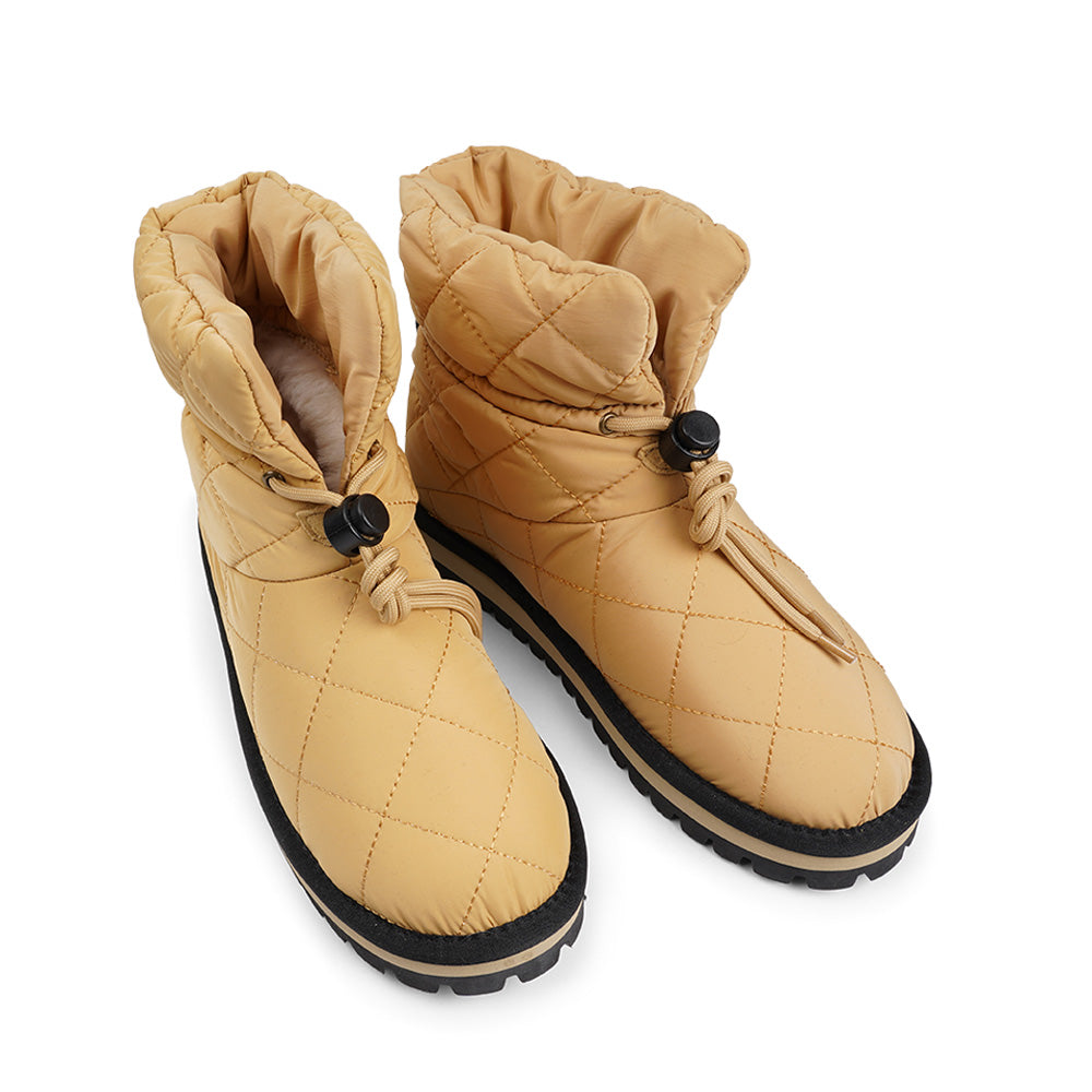 Lovelies Studio Nylon ankle boots with shearling lining. The shearling lining bring softness and warmth to your feet this autumn. With soft and durable rubber soles plus a gorgeous design you're perfectly suited for the wintertime. The Quilted nylon is water resistant and all shearling is from Australia. Outsole / Insole : Rubber 3 cm high Footbed: Shearling Lining: Shearling Upper: Quilted nylon LWG Environmental GOLD RATED Certification