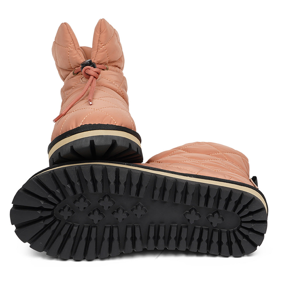 Lovelies Studio Nylon ankle boots with shearling lining. The shearling lining bring softness and warmth to your feet this autumn. With soft and durable rubber soles plus a gorgeous design you're perfectly suited for the wintertime. The Quilted nylon is water resistant and all shearling is from Australia. Outsole / Insole : Rubber 3 cm high Footbed: Shearling Lining: Shearling Upper: Quilted nylon LWG Environmental GOLD RATED Certification