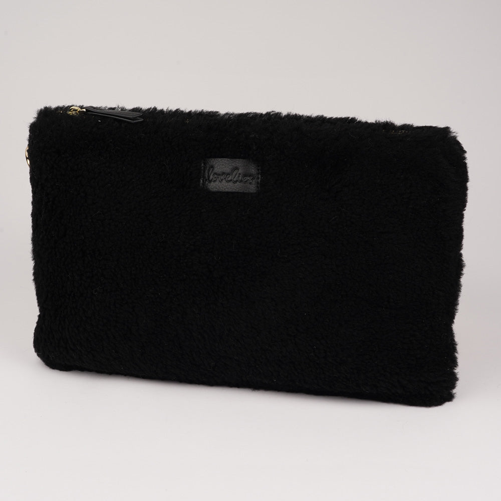 Lovelies Studio Wujii is a large shearling clutch which has room enough for your Ipad and notebooks . Wujii is hand made from the finest curly shearling from Australia. Top zipped closing Detachable wrist strap Satin lining and flat zipped inner pocket Item comes with a branded dust bag. Embossed Lovelies logo on the front Gold-toned hardware Measurements W34 X D2 X H22 cm 100 % Australian curly shearling