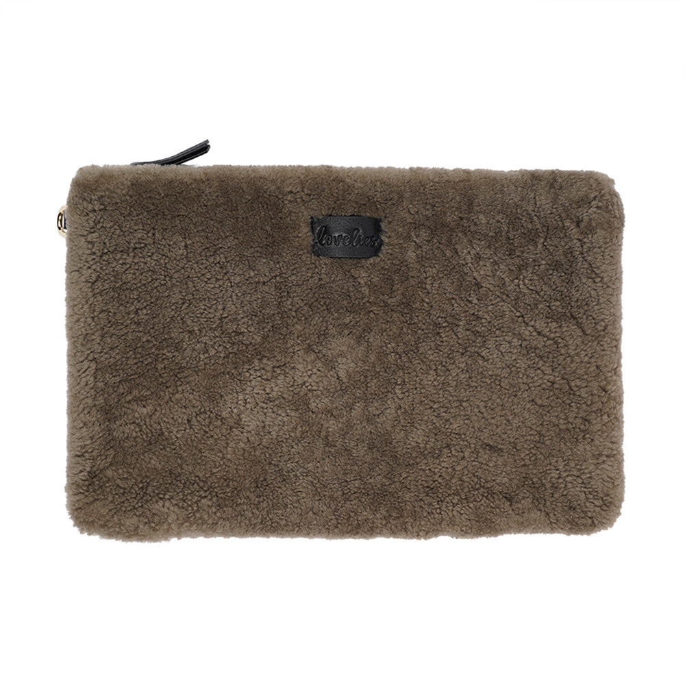 Lovelies Studio Wujii is a large shearling clutch which has room enough for your Ipad and notebooks . Wujii is hand made from the finest curly shearling from Australia.  Top zipped closing   Detachable wrist strap   Satin lining and flat zipped inner pocket   Item comes with a branded dust bag.   Embossed Lovelies logo on the front   Gold-toned hardware   Measurements W34 X D2 X H22 cm   100 % Australian curly shearling 